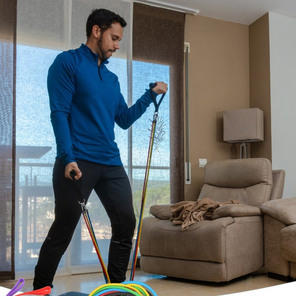 Man exercising with resistance bands in a living room