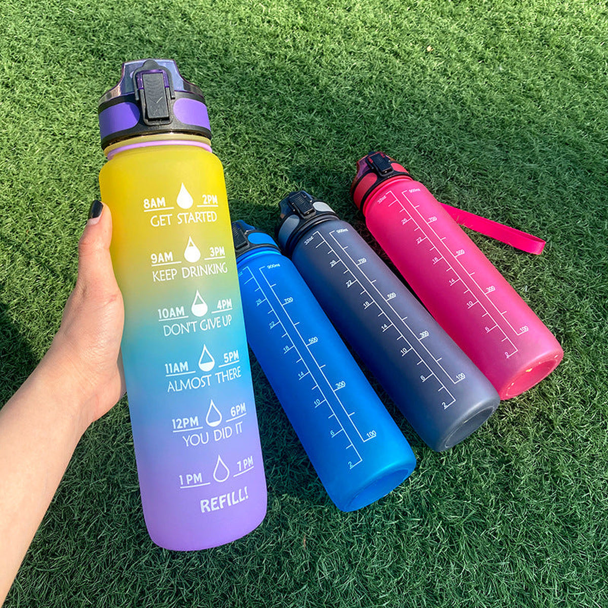 Water bottles standing on grass